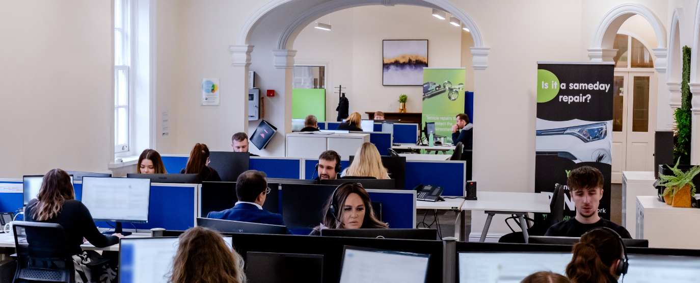 Image of support team at their computers