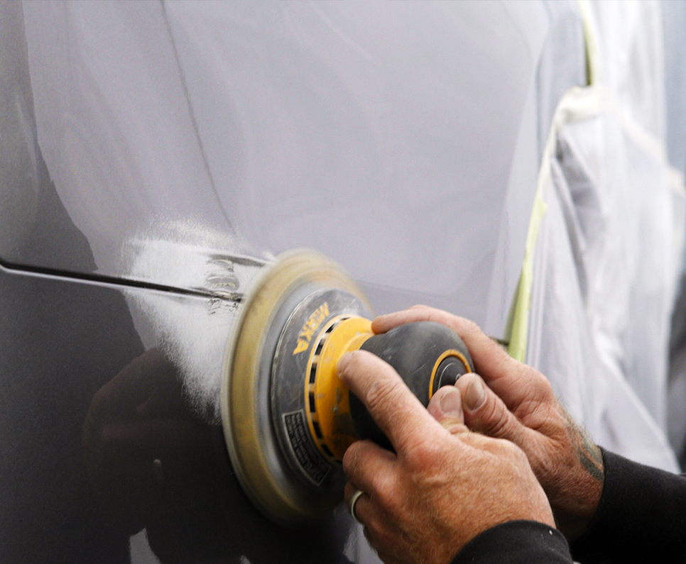 Delivering Uncompromising Quality, Every Time Close up of technicians hand buffing car panel