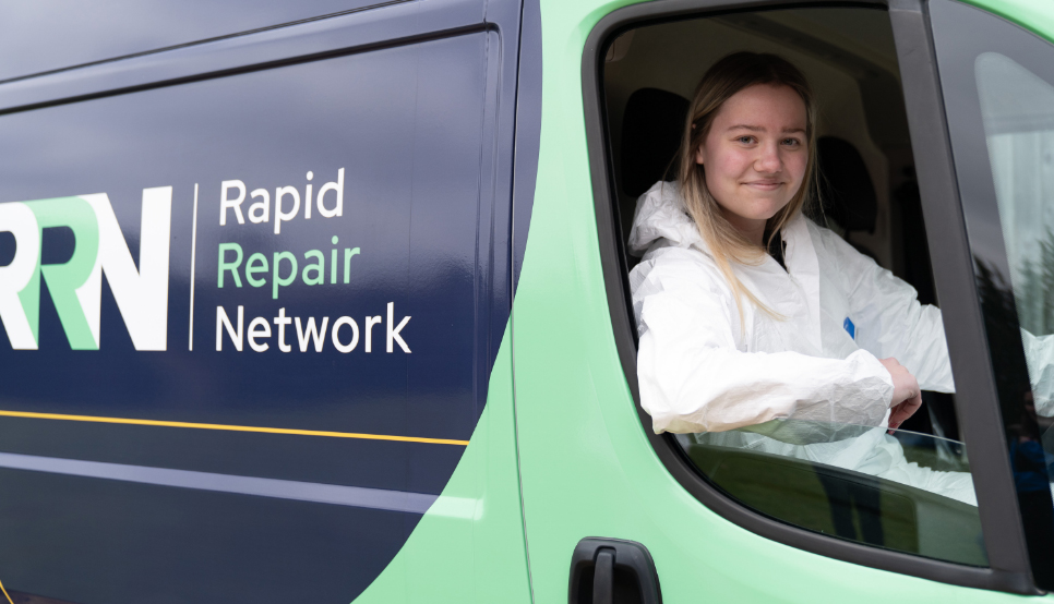 Female mobile repair technician smiling whilst in van